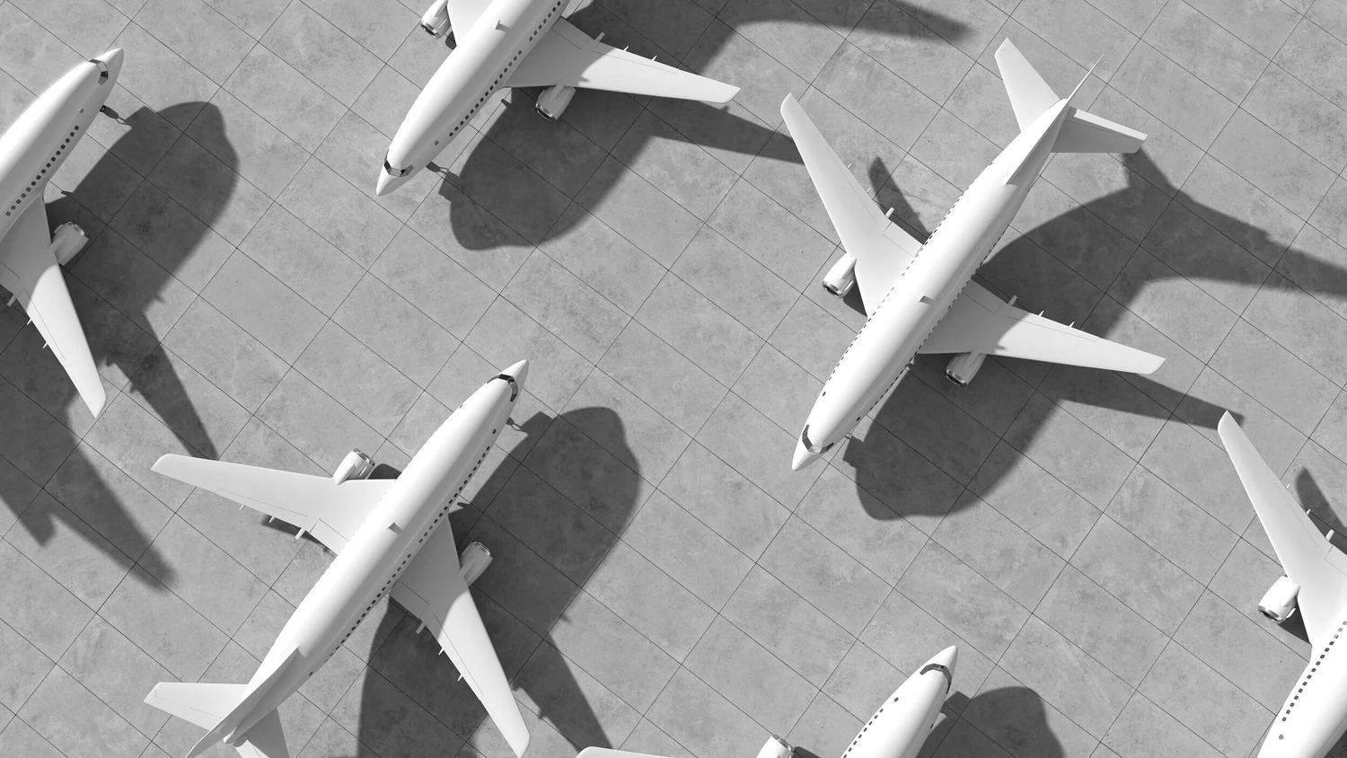 Airplanes parked on an airport apron, seen from above