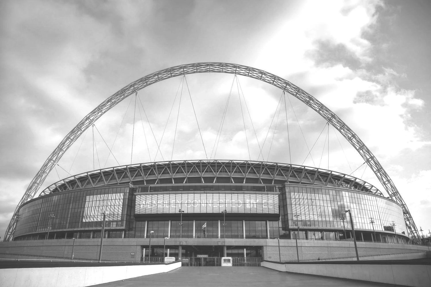 A large stadium beneath a steel arch